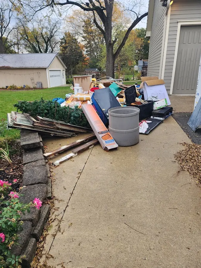 Dumpster being loaded with debris for Commercial Dumpster Rental in Baldwin